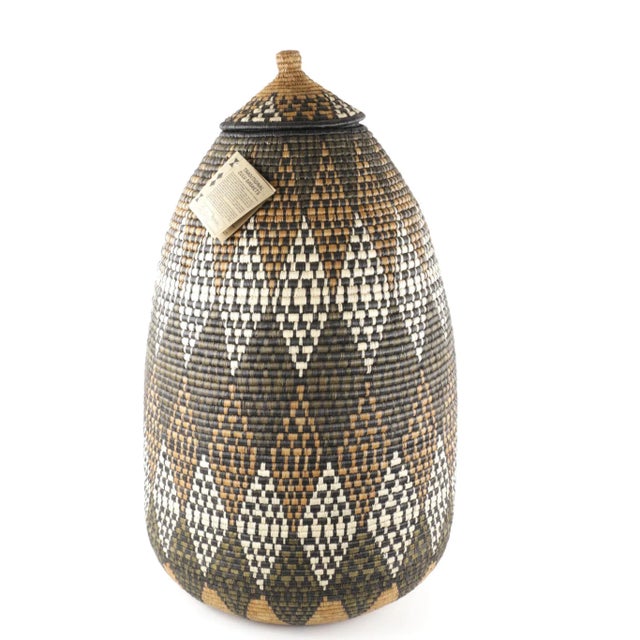 A basket handmade by the Zulu People in KwaZulu-Natal, South Africa. This ukhamba basket was woven by Mavis Mhlongo. This...