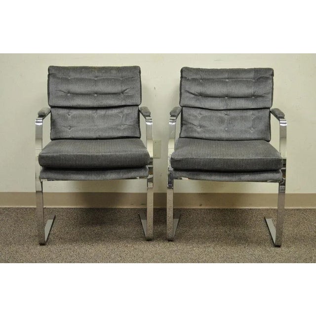Vintage Mid Century Modern Milo Baughman Style Chrome Steel Cantilever Arm Chairs - a Pair. Item features Sturdy and...