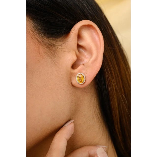 This is part of Chairish’s Fine Jewelry assortment. Oval Yellow Sapphire Diamond Halo Everyday Studs in 14K Gold to make a...