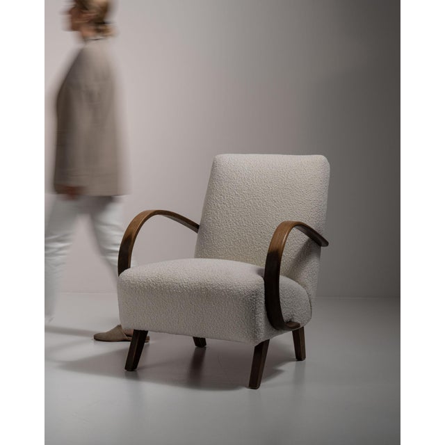 Bentwood-arm lounge chair in Warm Ivory Boucle. Finished in warm ivory boucle, this bentwood-arm lounge chair is...