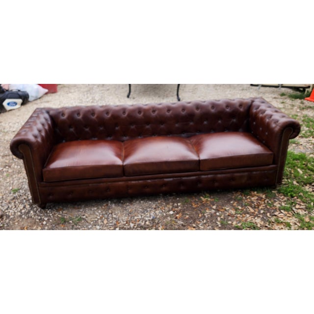 Great looking vintage brown chesterfield sofa. Very firm....cushions are attached. Needs some leather condition.