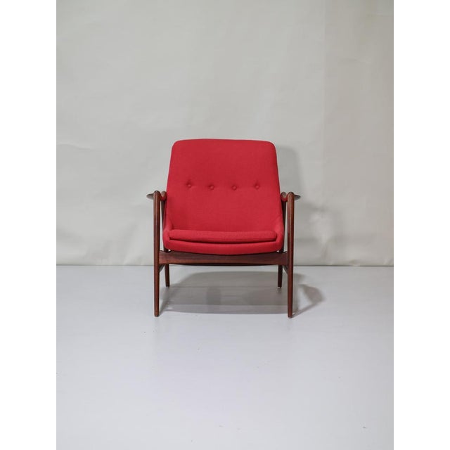 Beautiful red armchair designed by Rolf Rastad and Adolf Relling for Dokka Möbler, Norway, 1950s. This comfortable chair...