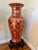 Beautiful oversized decorative floor vase featuring a rich deep red finish with intricate gold detailing throughout. The...