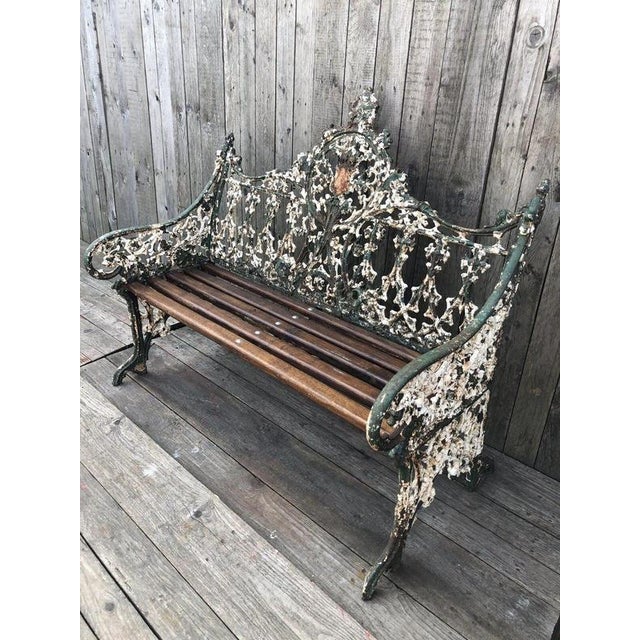 An exceptional original Coalbrookdale cast iron garden bench in the celebrated Gothic Revival pattern, retaining its...