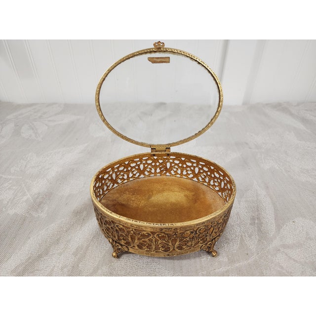 Home Inspirations is pleased to offer this vintage glass topped 24 k gold plated vanity box for your toiletries.