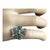 This exquisite Art Deco Ring showcases two emeralds and three diamonds set in 18 karat two-tone gold. The white-harp...