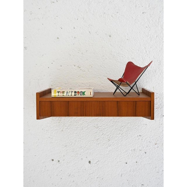 Scandinavian teak bedside table with integrated drawer. An original piece of furniture with minimalist lines typical of...