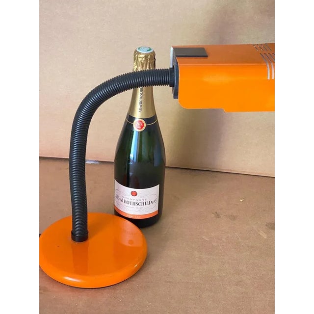 A Mid-Century Modern orange and black table lamp by Targetti. It works 110-240 volts and needs a regular e27 bulb. Lamp is...