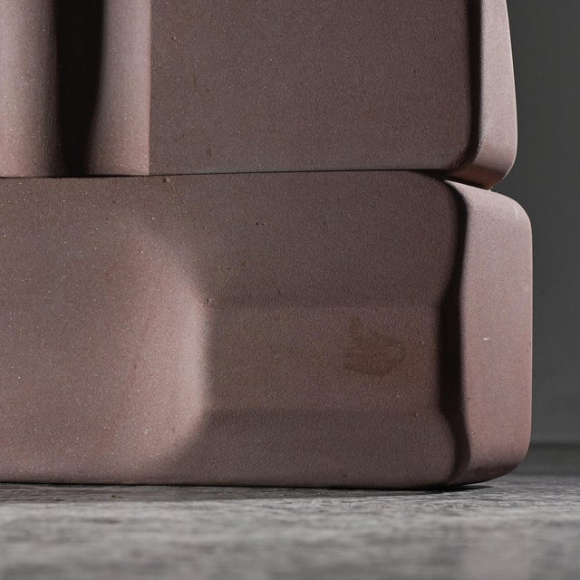 Pink sandstone sculpture created by Robert Neuhauser in Switzerland, circa mid-1980s. The piece develops a compact volume...