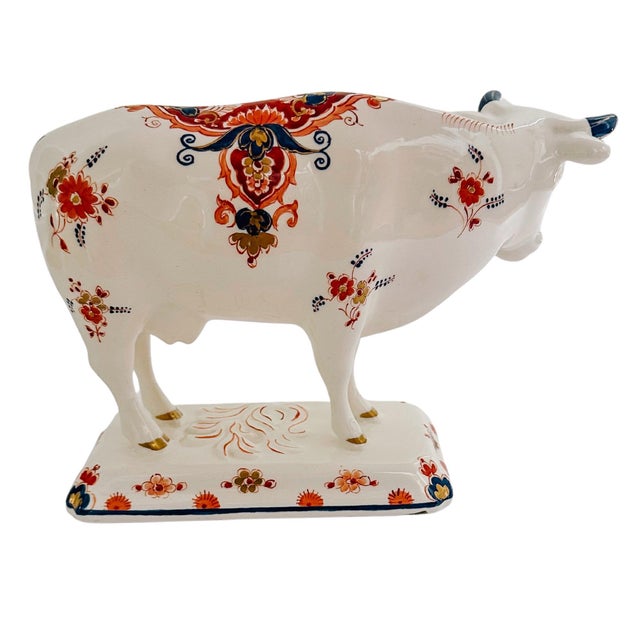 An original 1970s Dutch Delftware cow figurine by Royal Delft hand-painted with a polychrome floral decoration. Signed by...