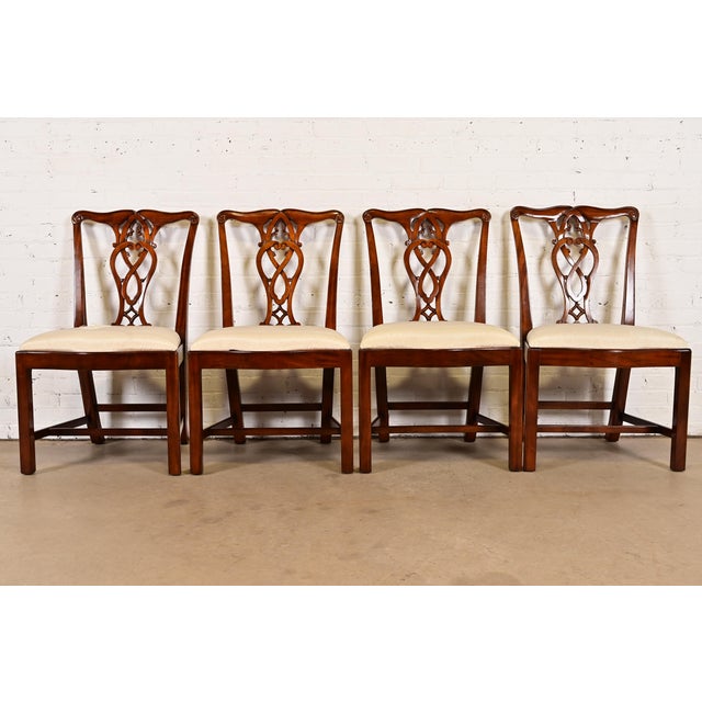 A gorgeous set of eight Georgian or Chippendale style dining chairs By Maitland Smith Late 20th Century Carved mahogany...