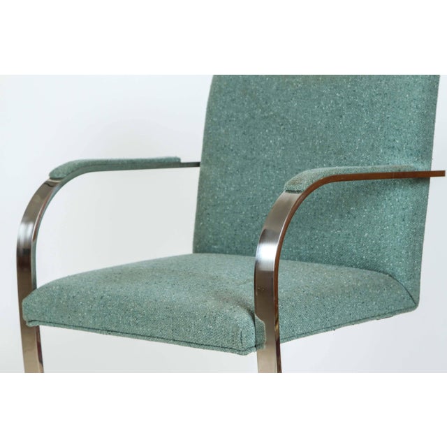 Pair of Ludwig Mies van der Rohe flat bar chairs for Knoll. Polished flat stainless steel frames upholstered in a Harris...