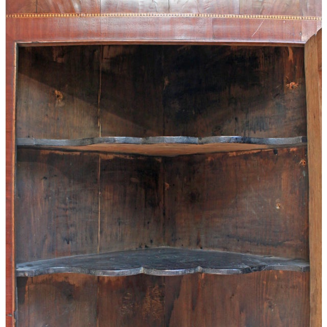 Circa 1830 Georgian Hanging Corner Cabinet, English. Oak with mahogany bandings & accents. Conch shell inlay with sycamore...