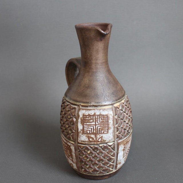 French vintage ceramic pitcher by alexandre kostanda, vallauris, france (circa 1960s). In his trademark natural clay and...