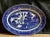 An oval “Blue Willow” serving platter with a geometric border and a traditional scenic center.