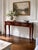 A charming vintage Queen Anne style console table featuring graceful cabriole legs, a rich mahogany finish, and three...