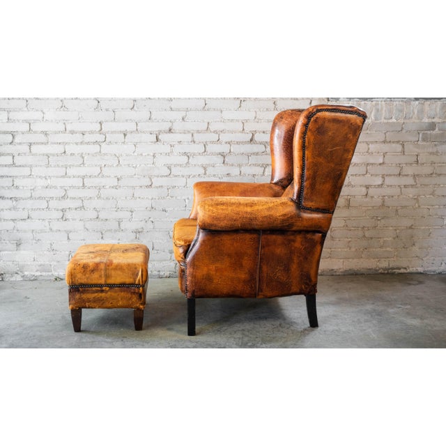 1970s Vintage Art Deco Distressed Cognac Leather Wingback Chair & Ottoman For Sale - Image 13 of 16