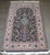 A mid-20th-century Persian Isfahan Prayer Carpet. The jade field with birds amongst a flowering vase, vinery, and a floral...