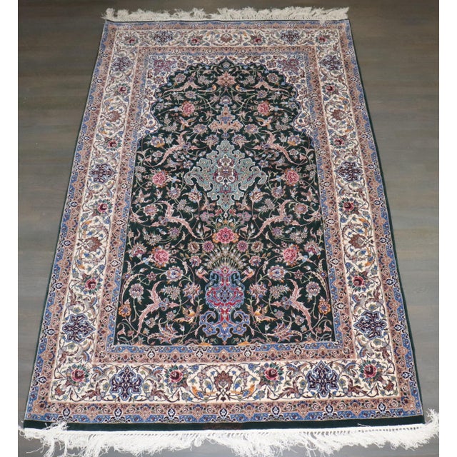 A mid-20th-century Persian Isfahan Prayer Carpet. The jade field with birds amongst a flowering vase, vinery, and a floral...