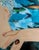 Portrait of a thoughtful model/mermaid (?) with colorful fish flowing around her, an original mixed media collage with...