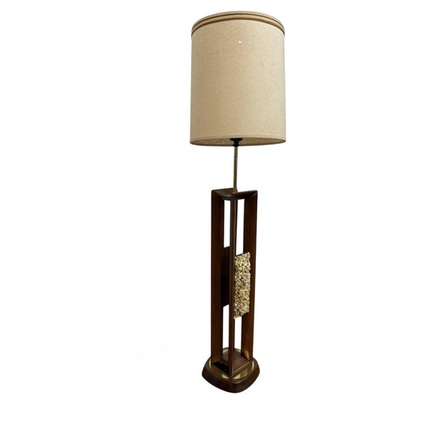 This Mid-Century Modern Walnut Brass Sea Shell Table Lamp with its original drum shade is a stunning vintage piece from...