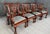 This set of eight solid mahogany dining chairs features finely carved pierced splat backs with shell crest rails, cabriole...