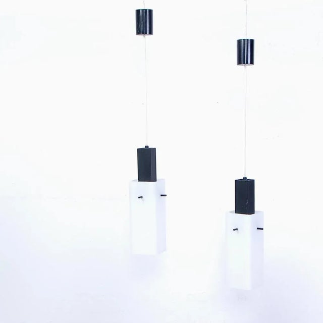 Beautiful pair of vintage chandeliers, about 1950s production. The electric cable directly supports the white opal glass...