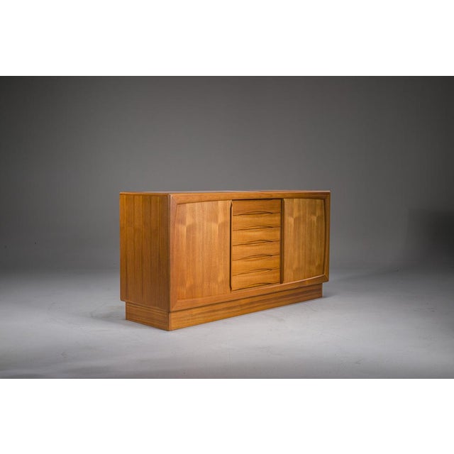 Elegant Danish teak sideboard by Dyrlund, dated 1987 and signed with the original stamp on the back. This refined...