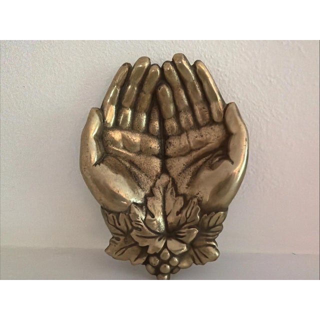 This antique solid brass cupped hands jewelry trinket dish from the early 1900s is a unique decorative piece that can be...