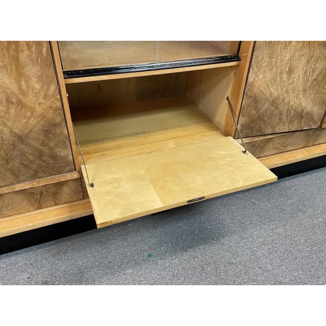 This beautiful burlwood cabinet is a true statement piece for any room. The intricate French Deco style adds a touch of...