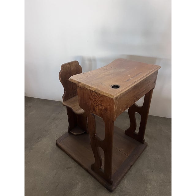 A single children's school desk with a table and seat from the late 1800s. The frame is made entirely of poplar wood....