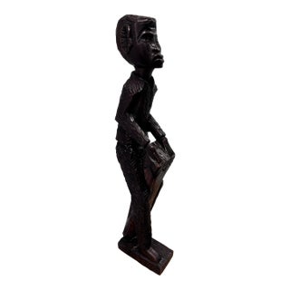 Vintage Hand-Carved Wooden African Tribal Figurine Depicting a Man Playing a Drum, Crafted From Dense Hardwoods Like Ebony For Sale
