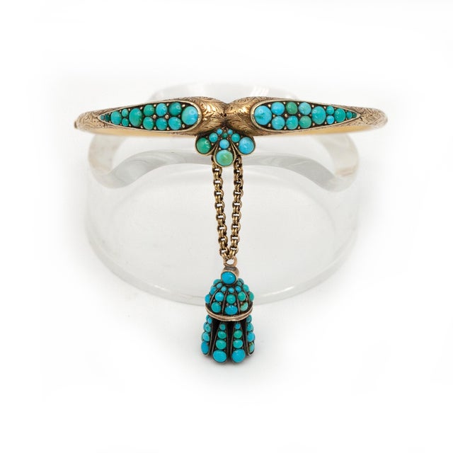 Antique Victorian 18K yellow gold turquoise engraved hinged bangle with a turquoise charm Approximate Weight: 15.8 grams...