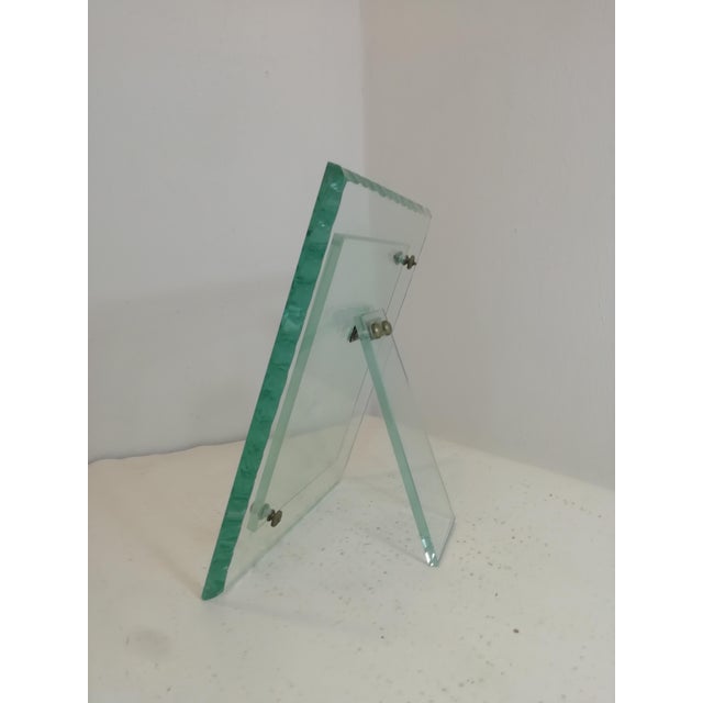 Beautiful and rare table photo frame in Nile green glass. Brass and metal inserts. Hot chiselled edge. A truly beautiful...