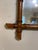 This is a French antique faux-bamboo wall mirror with a hand-carved wood frame. The frame is wood that has been shaped and...