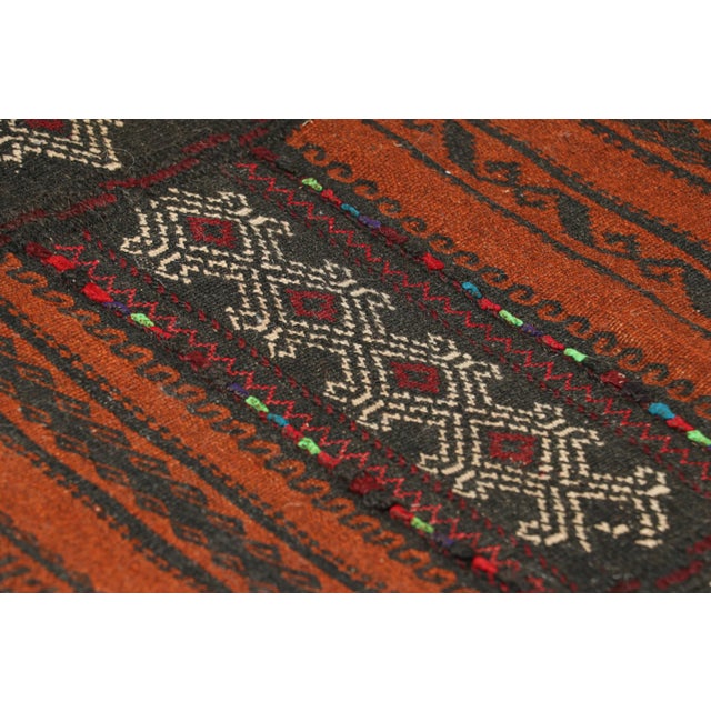 Handwoven in wool, circa 1950-1960, this 2x5 vintage Afghan tribal kilim, is a collectible tribal piece that may have been...