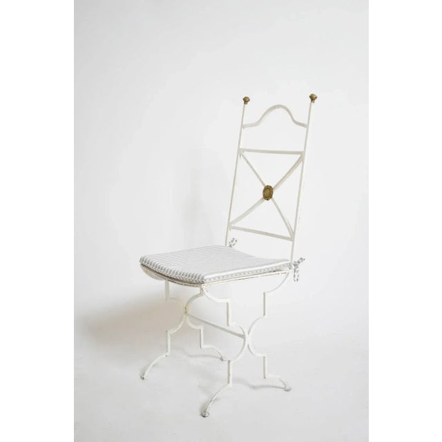 Set of four white wrought iron chairs, 1940s Set of 4 neoclassical white lacquered wrought iron chairs with bronze details...