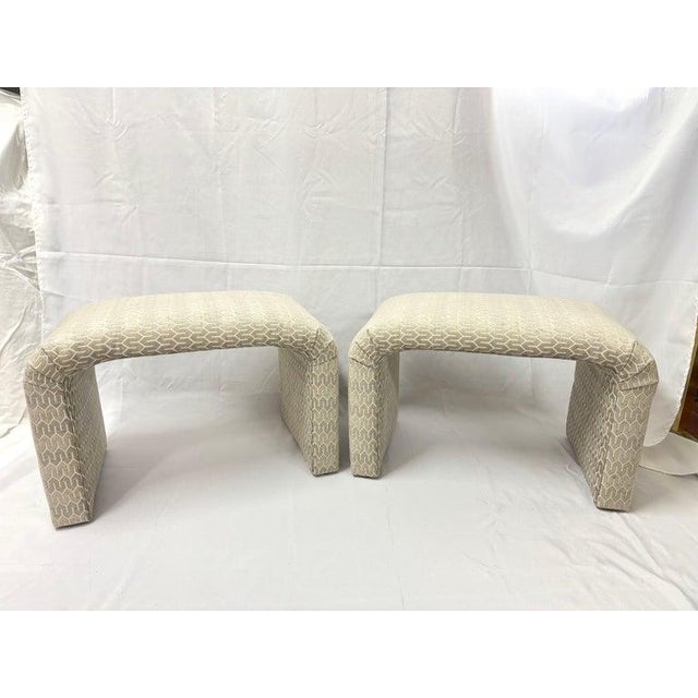 Pair of Waterfall Ottomans in Cream. Newly recovered. Post modern shape with a timeless design. Use pair under a console...