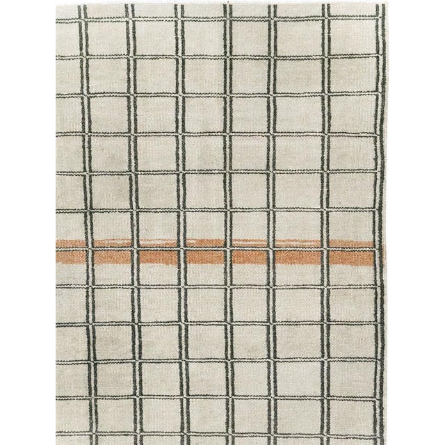 This mid-20th-century Turkish Anatolian accent rug presents a disciplined grid of hand-drawn rectangular compartments...