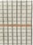 This mid-20th-century Turkish Anatolian accent rug presents a disciplined grid of hand-drawn rectangular compartments...