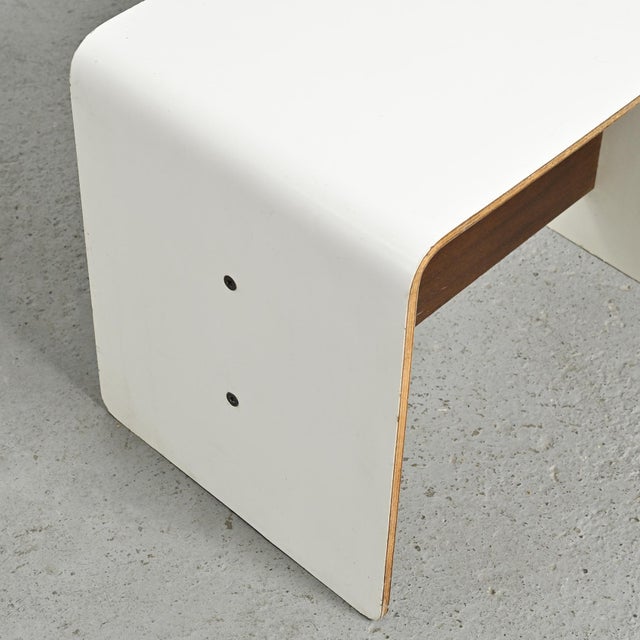 Bedside table designed by Pierre Guariche to furnish apartments in La Plagne and Bandol. Made of U-shaped curved plywood,...