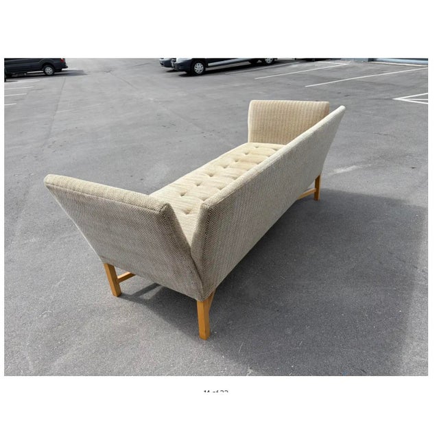 Designer Sofa with Wood X-Base Stretcher. Covered in thick beige and gray herringbone fabric.