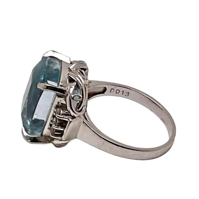 This striking vintage cocktail ring is centered with an emerald cut aquamarine, weighing approximately 7 carats, in a...