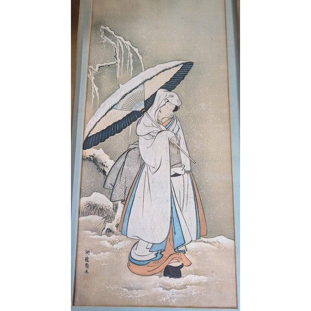 This Japanese ukiyo-e artwork depicts a young woman walking in the snow, created by the Edo-period artist Isoda Koryūsai....