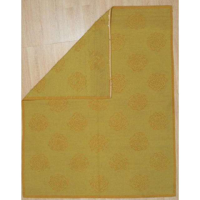 This yellow, gold, and orange wool rug is a flat weave Dhurrie style floor covering crafted in China. It features a medium...