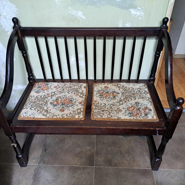 midcentury dark wood bench two sides seperating two 2cushions attatched to seating"seating upholstered tapestry material...