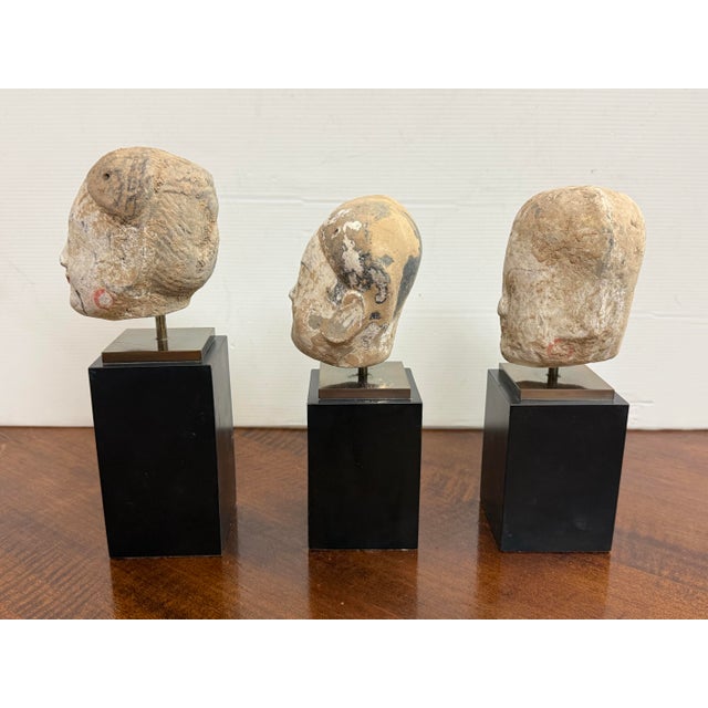 Design Plus Gallery presents a Set of Three Vintage Asian Decorative Heads + Stands. Each head shows hand-formed facial...