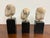 Design Plus Gallery presents a Set of Three Vintage Asian Decorative Heads + Stands. Each head shows hand-formed facial...