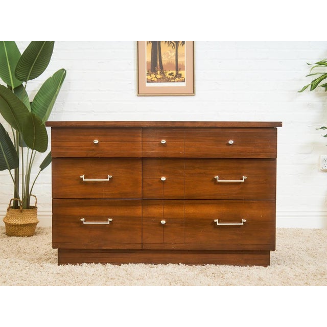 This handsome Six drawer dresser captures the sleek minimalism of classic mid-century design. Constructed with warm walnut...