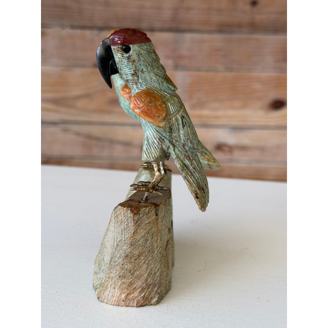 A charming vintage Peruvian hand-carved gemstone parrot sculpture featuring two birds perched atop a carved stone base....